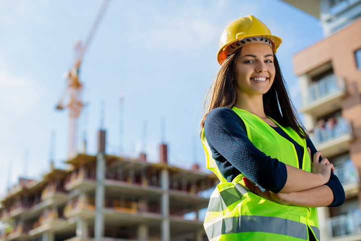 Young female engineer smiling at construction site